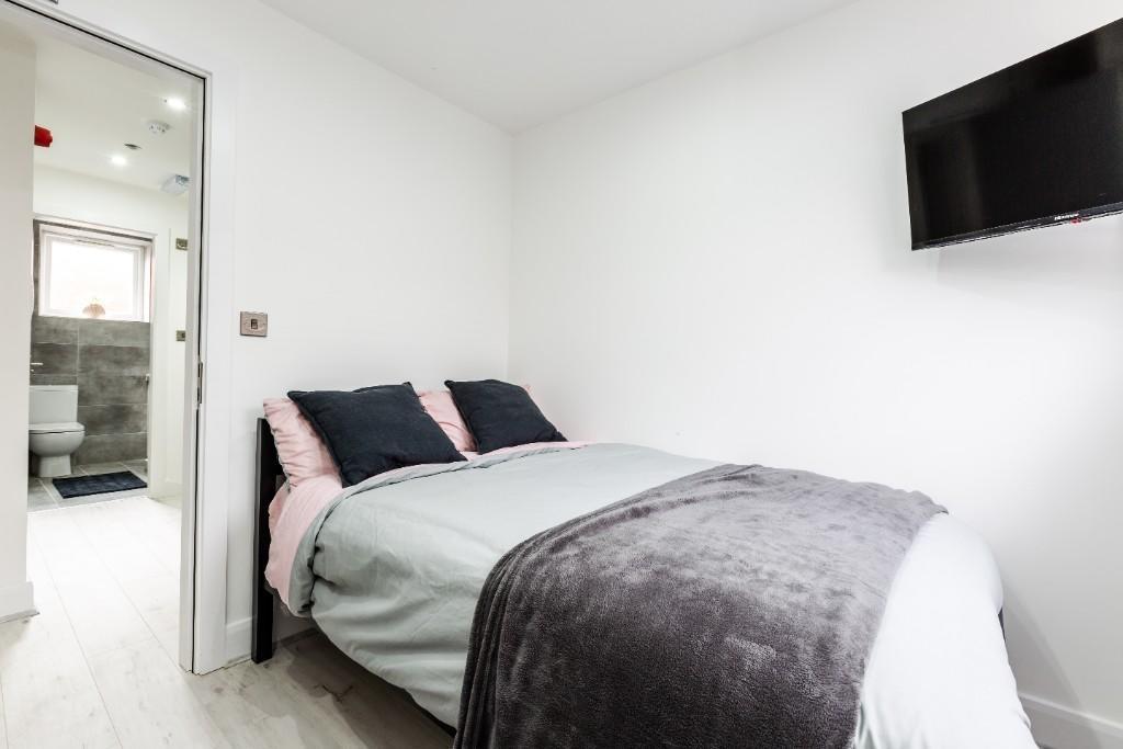 A bright and modern master bedroom featuring a ...
