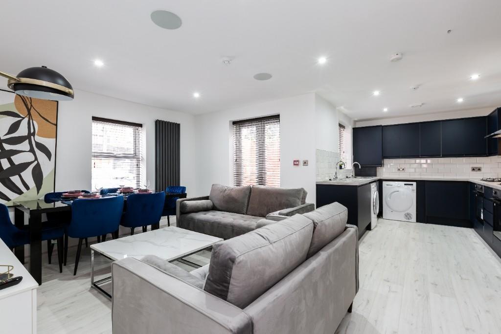 A spacious and modern living room featuring con...