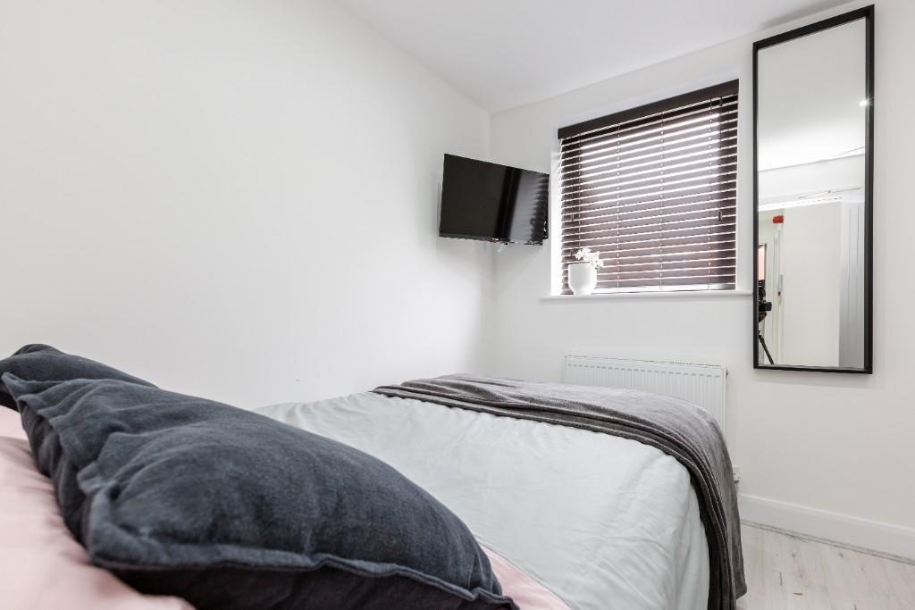 A bright and inviting double bedroom featuring ...