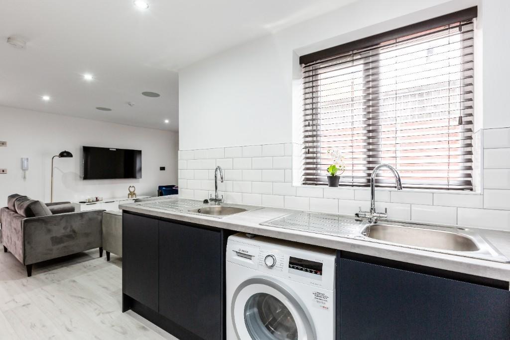 Modern and bright kitchen with large windows of...