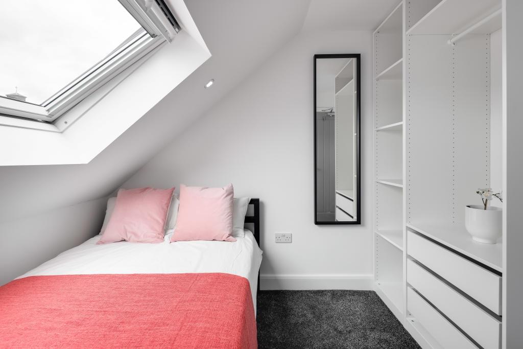 A bright and tidy double bedroom featuring a co...