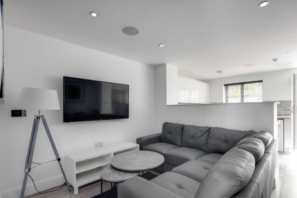 A modern and spacious living room featuring a l...