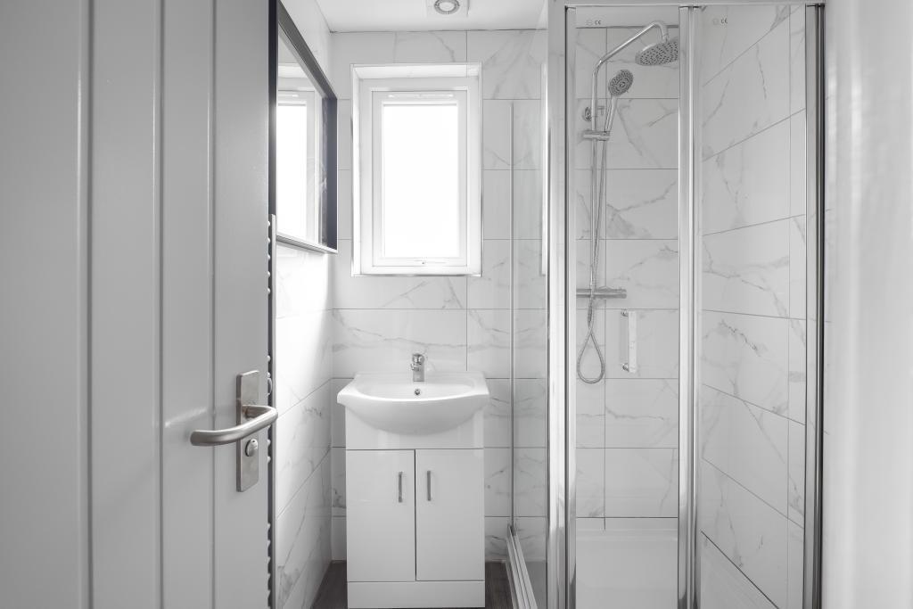 A modern and clean bathroom with a spacious sho...