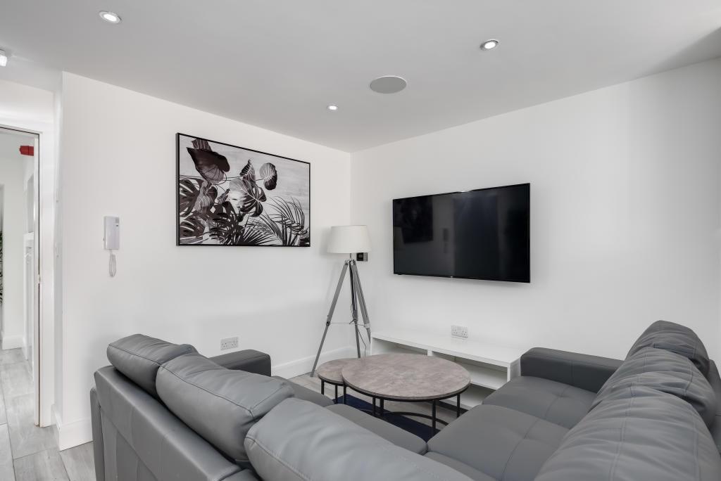 A spacious and modern living room featuring a c...