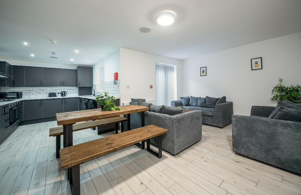 A spacious and modern living area featuring com...