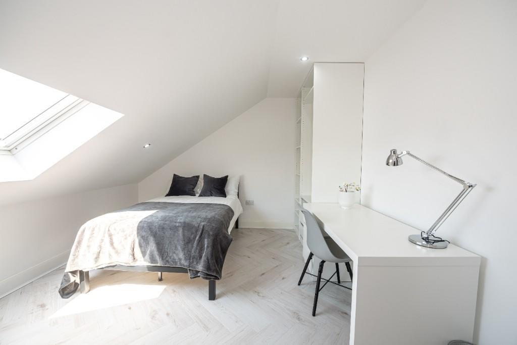 Bright and airy bedroom with a comfortable doub...