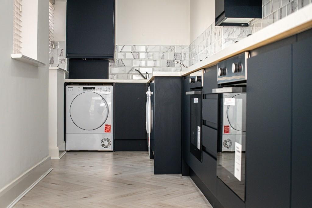 A modern, well-organized kitchen with sleek dar...