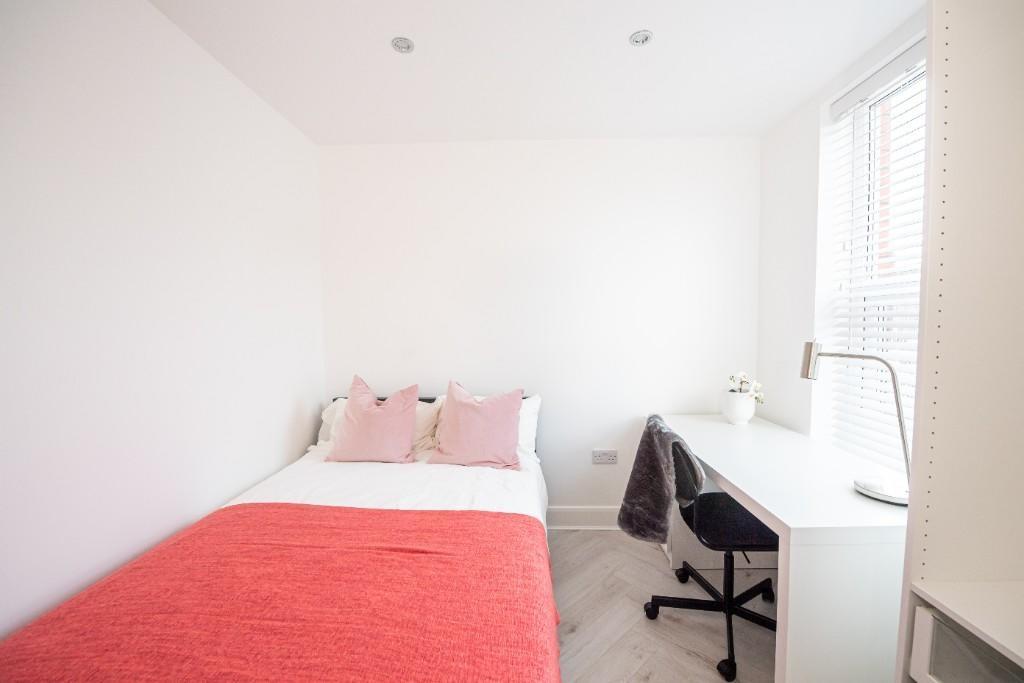 A bright and inviting double bedroom featuring ...