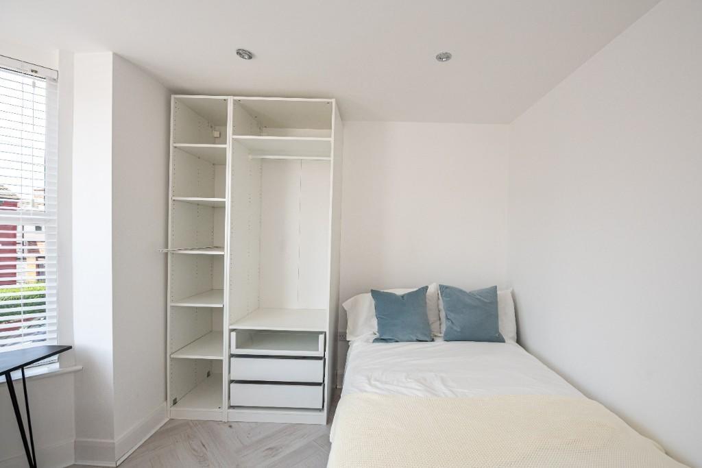 A bright, well-maintained double bedroom featur...