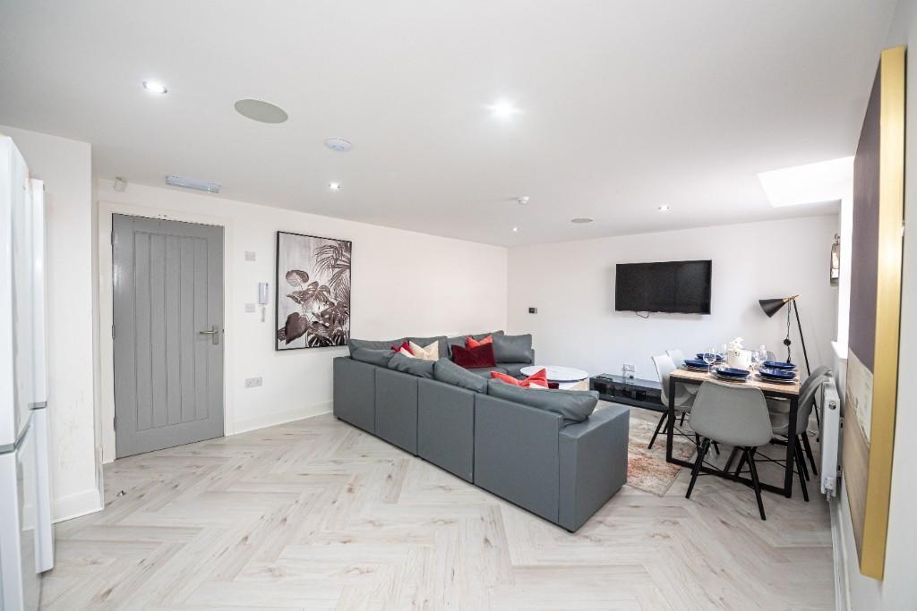 A bright, modern living room featuring a large ...