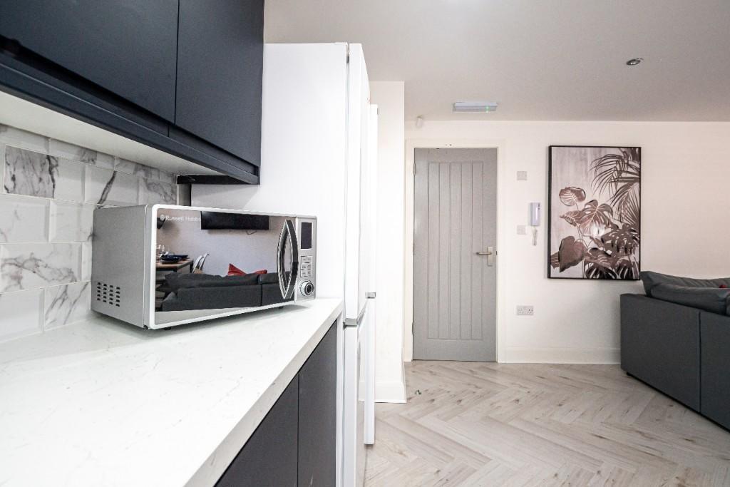 A clean, bright kitchen with modern appliances ...