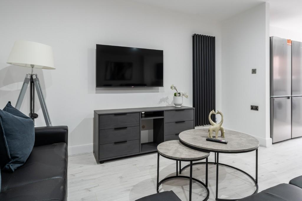 A modern and stylish living room featuring a sl...