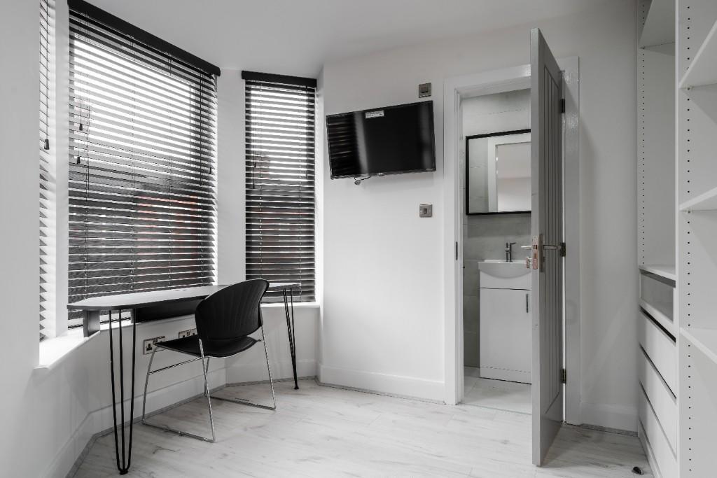 A well-maintained bathroom featuring a large ba...