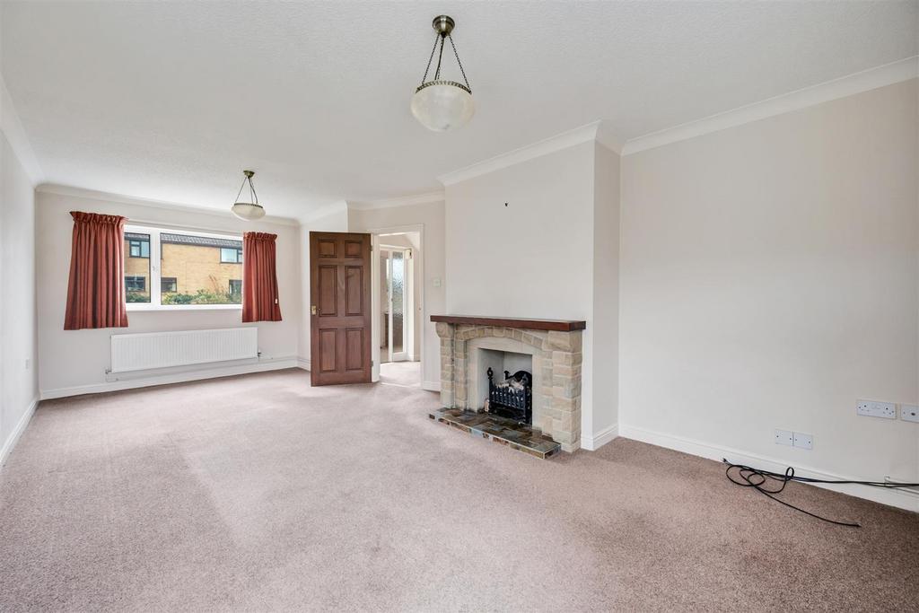 Sitting Room to front window and fireplace.jpg