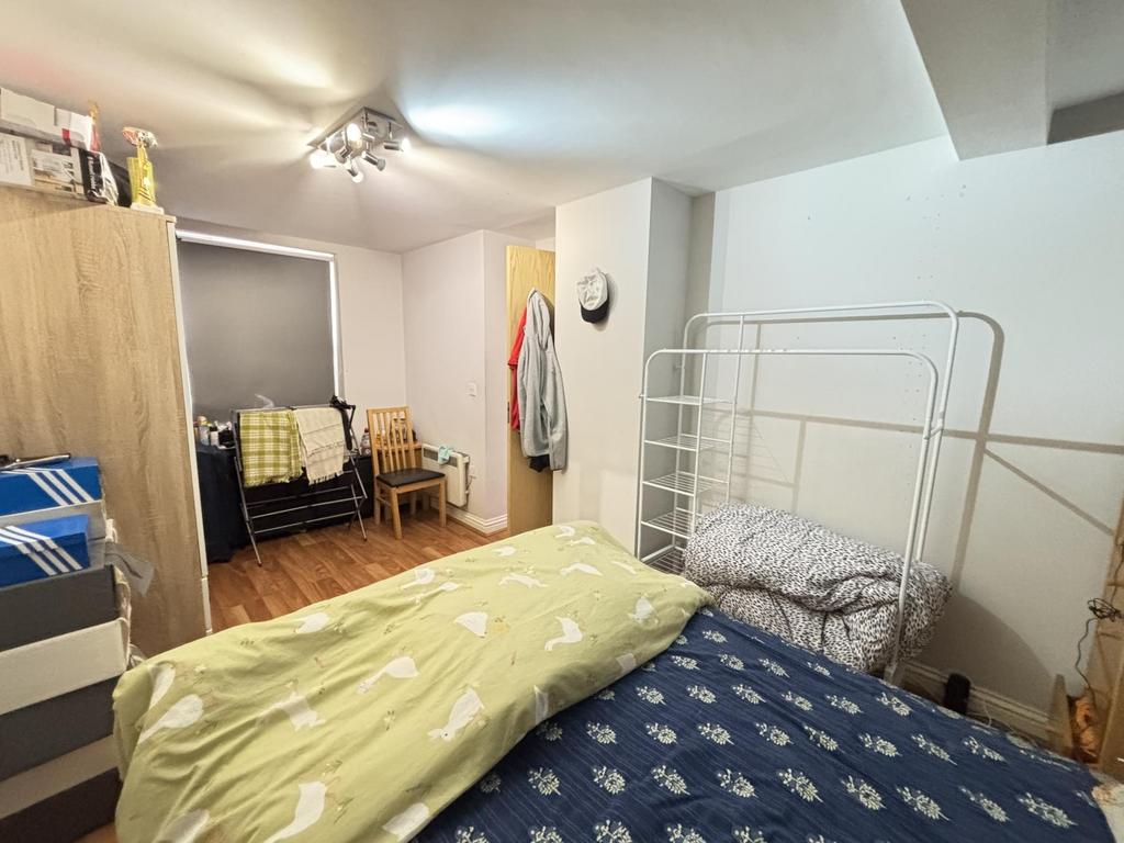 A cozy and well-maintained bedroom with a simpl...