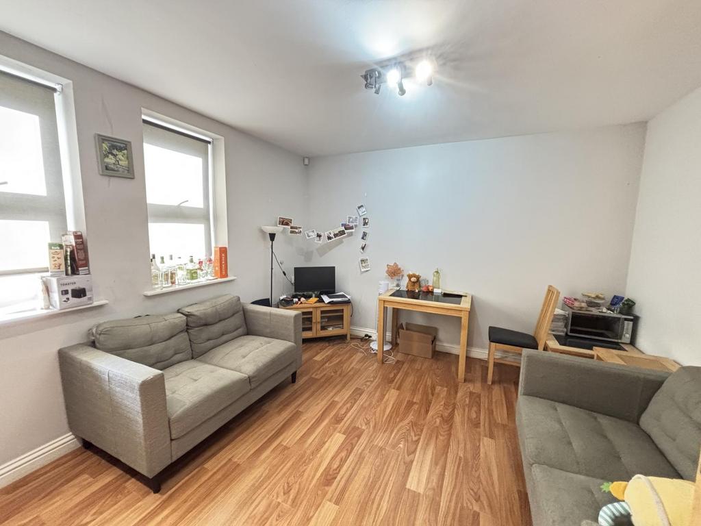 A bright and welcoming living room featuring co...