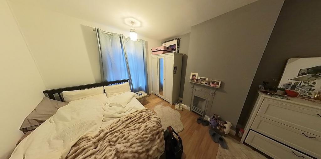 A bright and welcoming bedroom with a large bed...