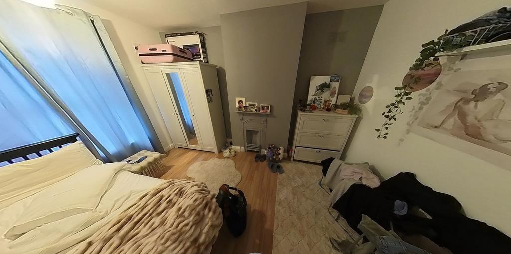 A comfortable bedroom featuring a double bed, a...