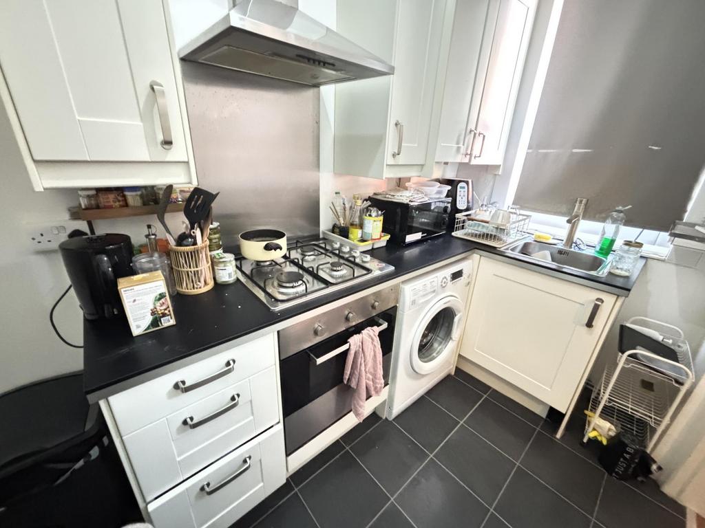 A modern kitchen with ample counter space, stai...