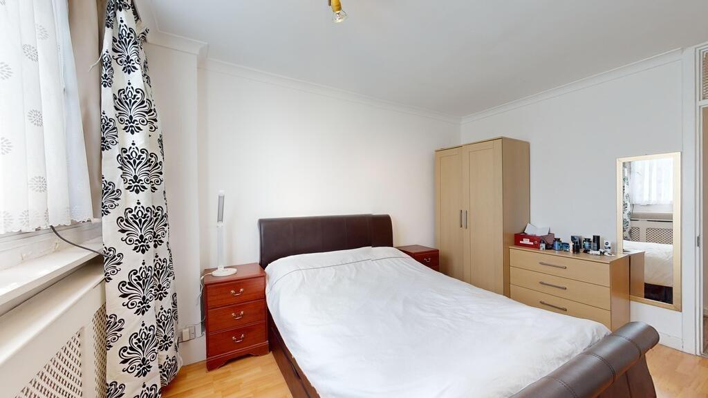 A spacious and neatly presented master bedroom ...