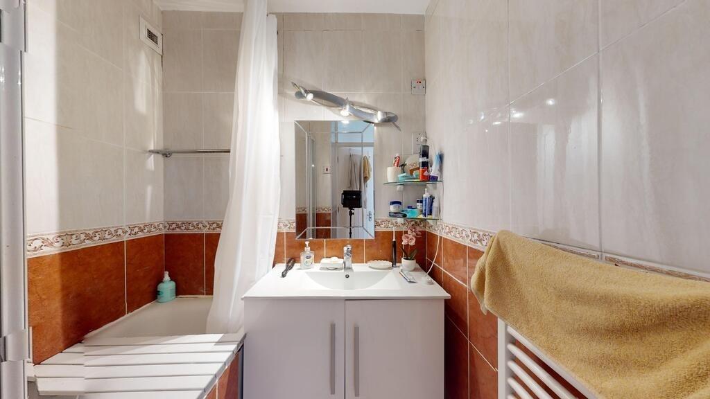 Clean and functional bathroom with a bathtub, m...