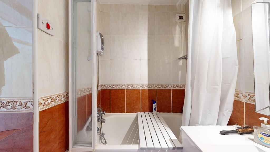 A modern bathroom featuring a bathtub with an o...