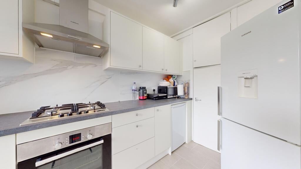 A modern, clean kitchen with white cabinets, a ...