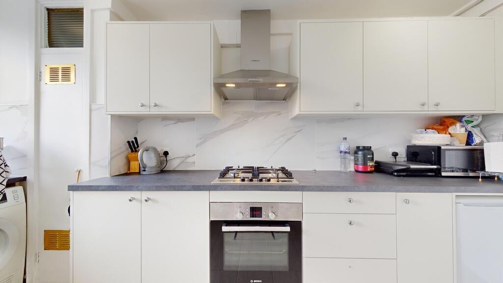 Bright and clean kitchen featuring modern white...