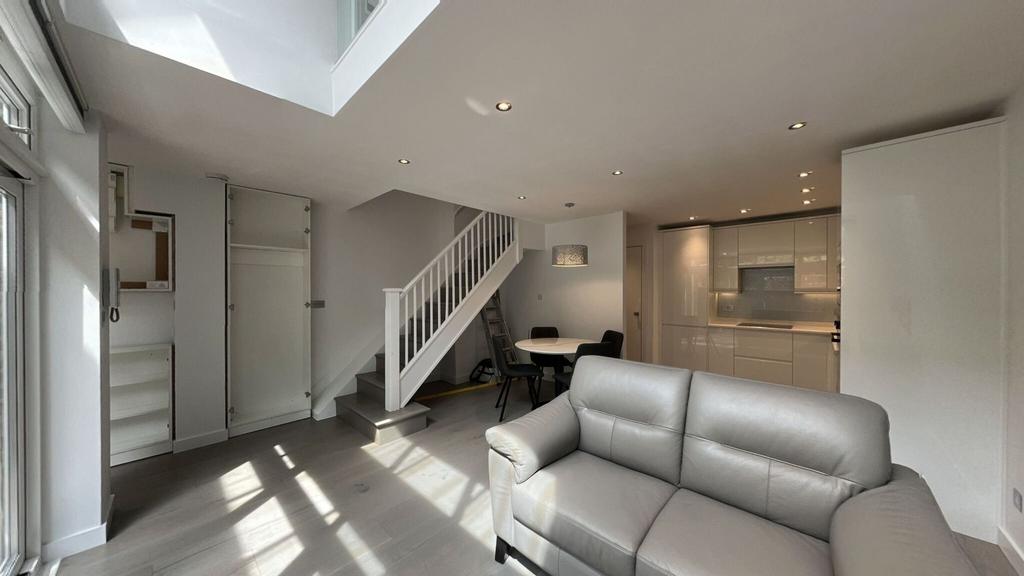 Bright and modern living area with ample natura...