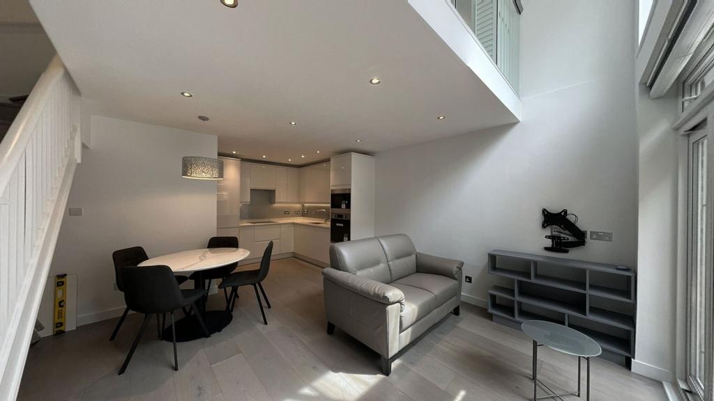 Modern and bright living room featuring an open...