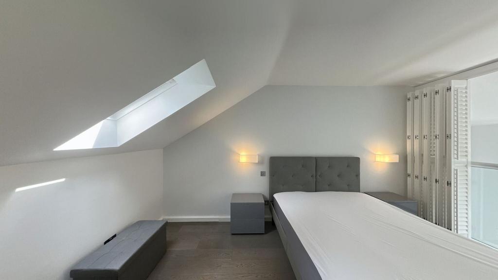 Bright and modern bedroom with a large window s...