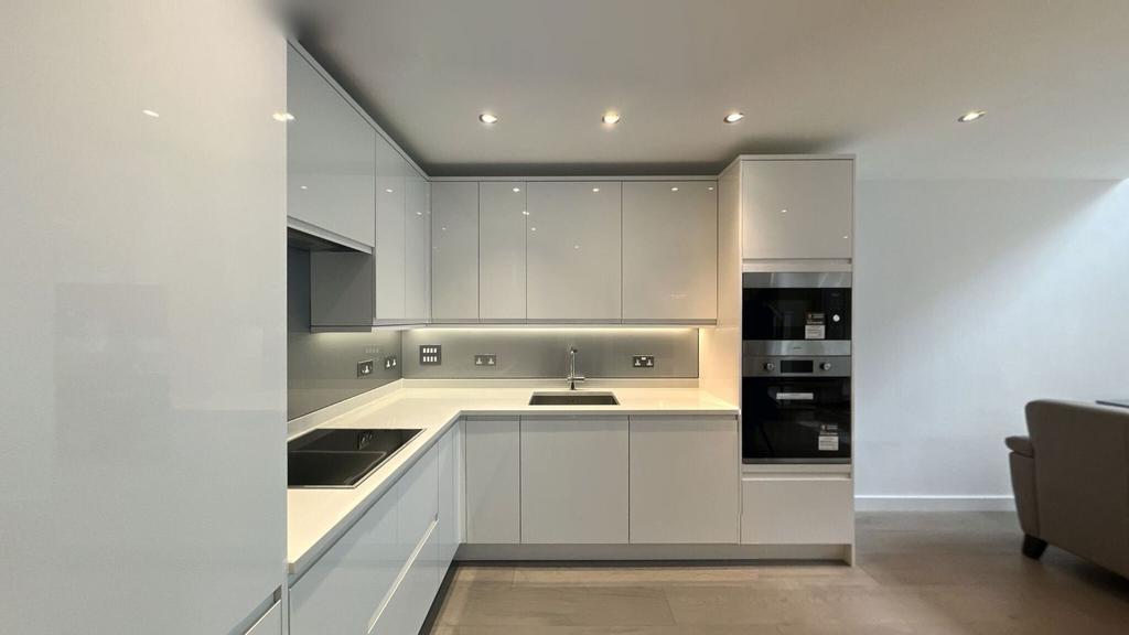 Modern and sleek kitchen with minimalist white ...