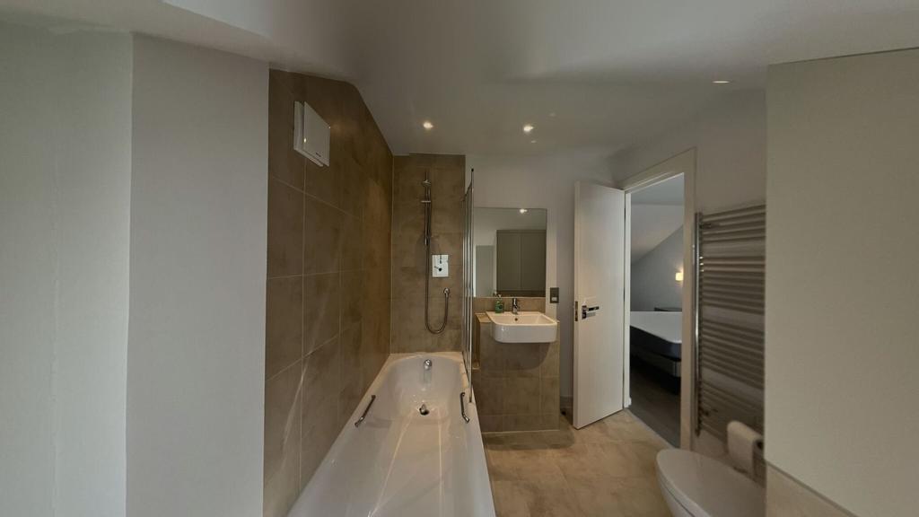 Modern and clean bathroom featuring a spacious ...