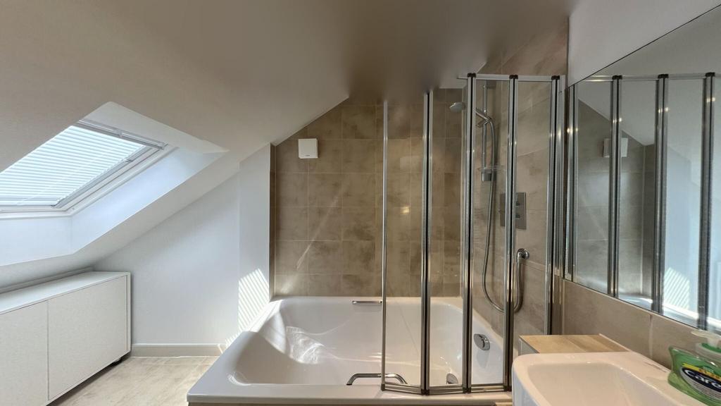 Bright, modern bathroom with a spacious shower ...