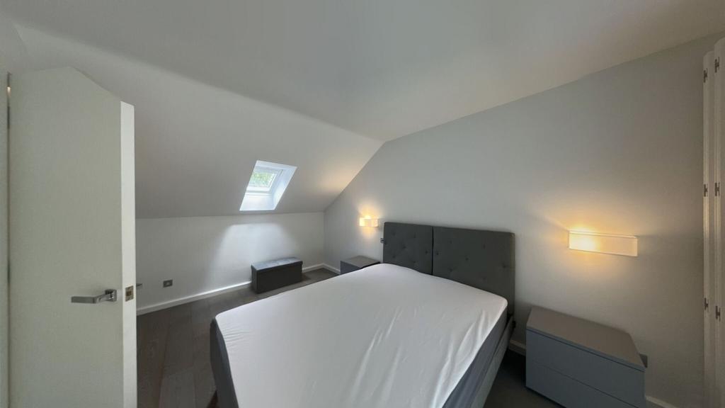 A bright and modern double bedroom featuring a ...