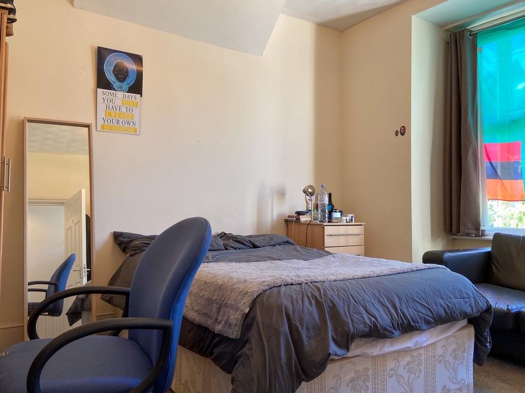 A cozy bedroom with a double bed, a window prov...