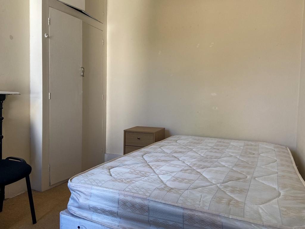 A spacious, well-maintained master bedroom feat...