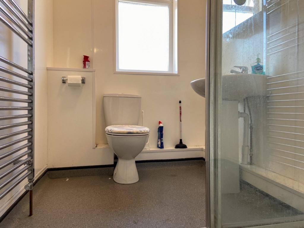 A clean and bright bathroom with a modern toile...