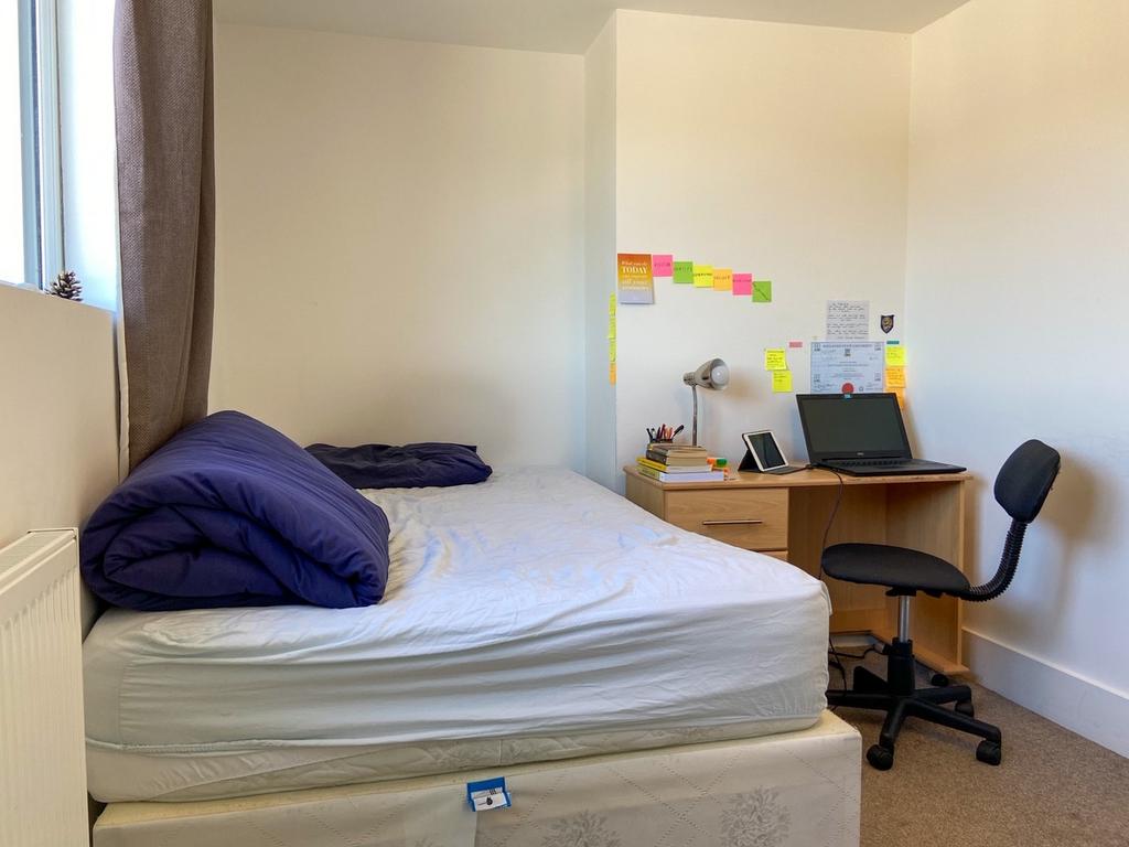A comfortable double bedroom featuring a neatly...