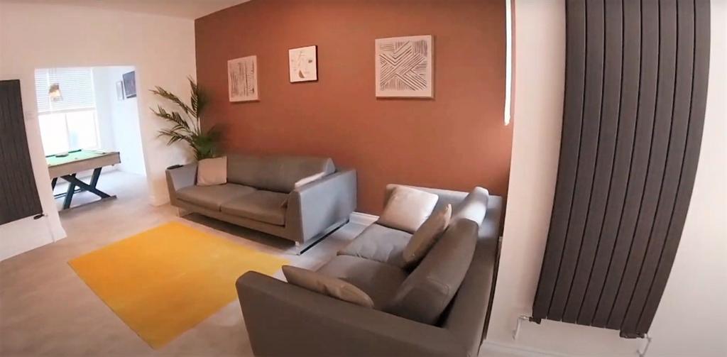 A spacious, modern living room featuring comfor...
