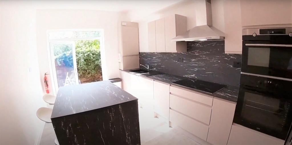 Modern kitchen with sleek cabinetry and a spaci...