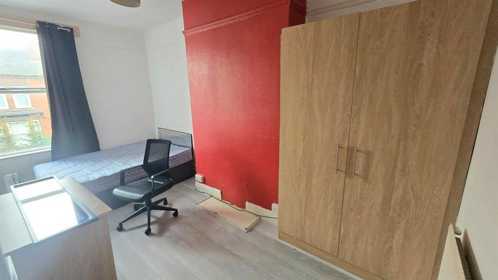 A bright and tidy bedroom featuring a large war...
