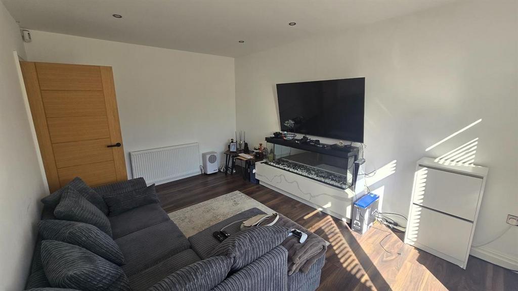 A spacious and well-lit living room featuring a...