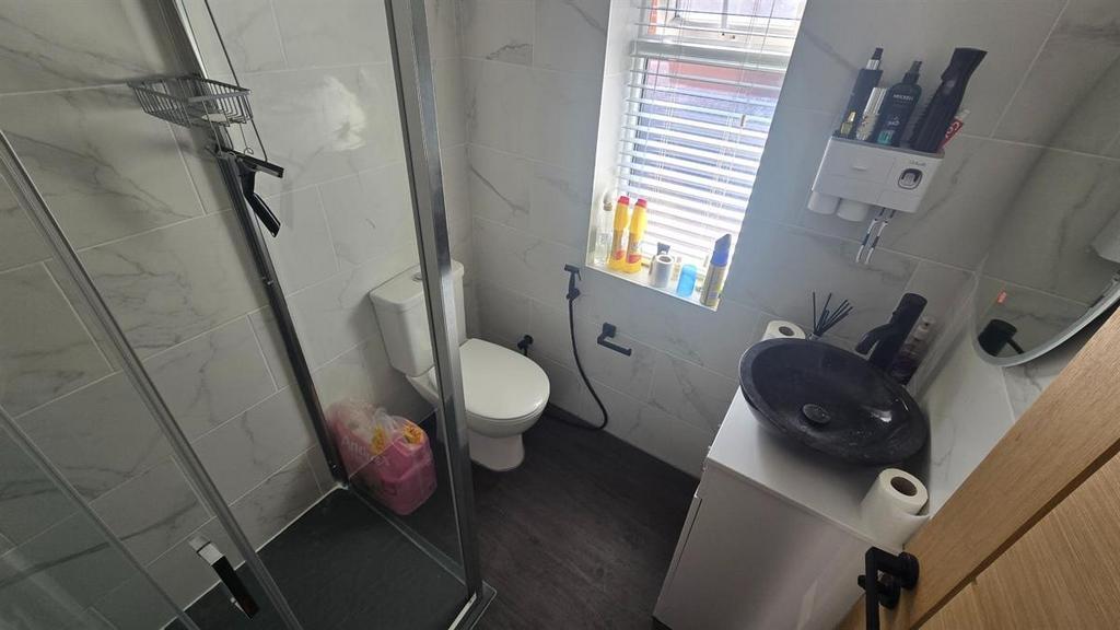 A modern and tidy bathroom with a shower cubicl...