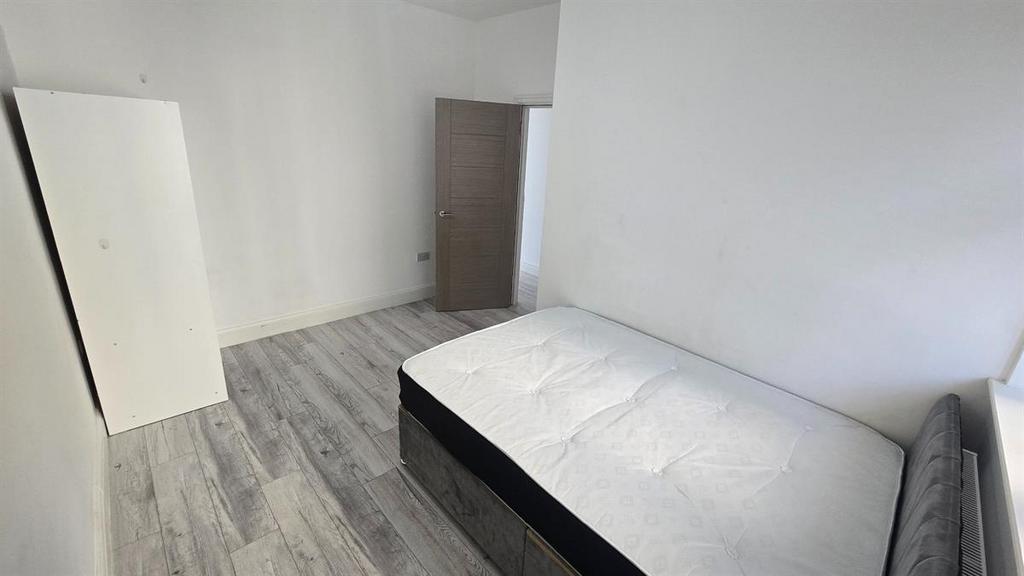 A small, clean toilet with minimal visible feat...