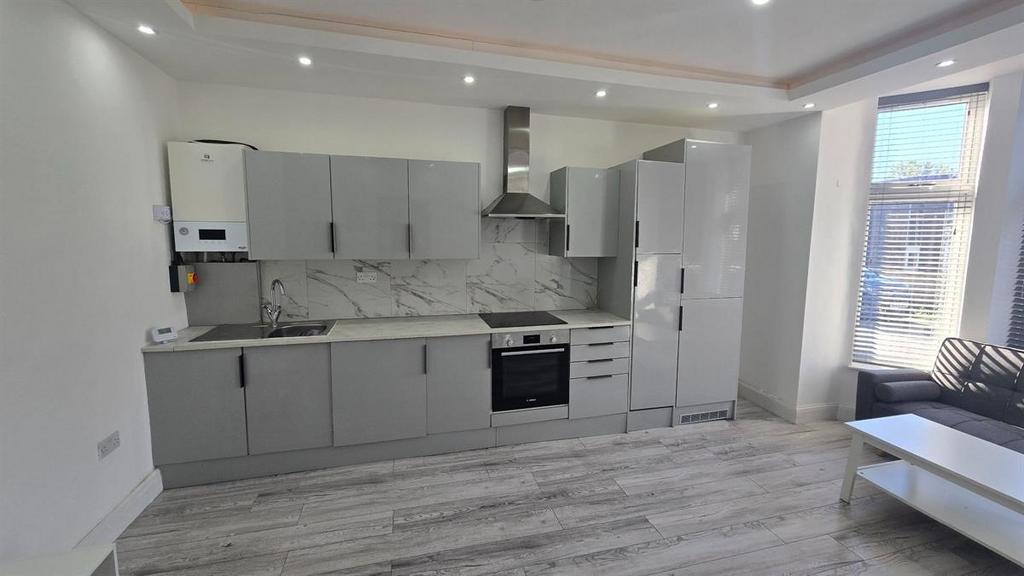 A modern, well-lit kitchen with clean surfaces ...