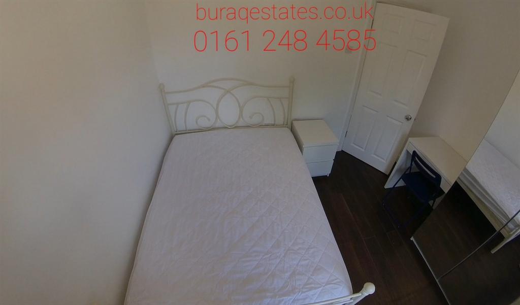 A tidy bedroom with a double bed, featuring a s...