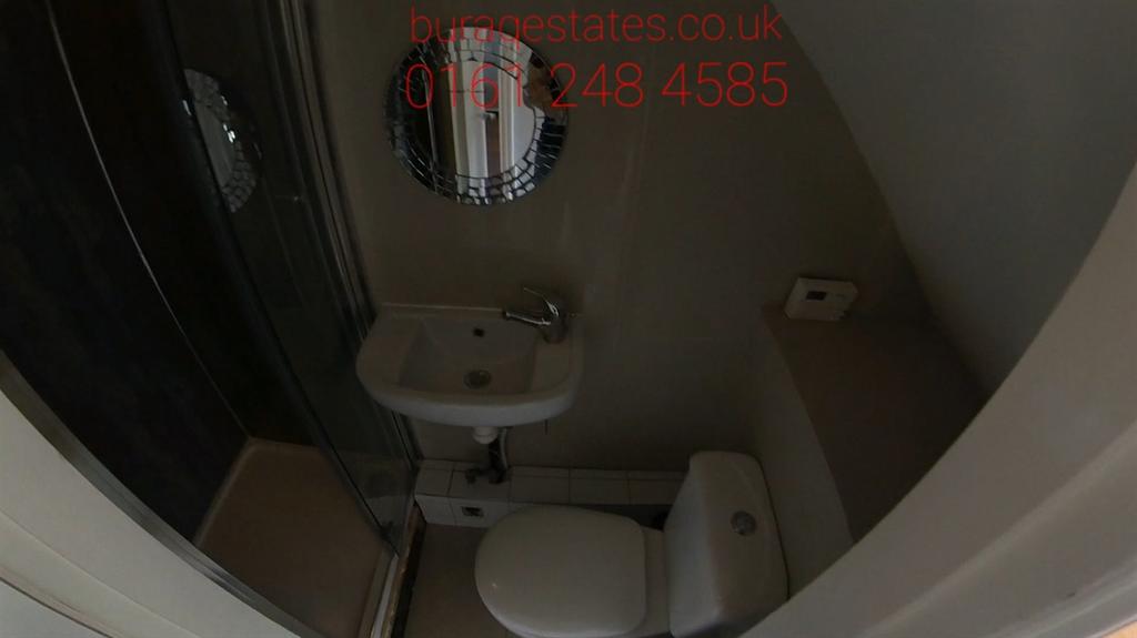 A tidy bathroom with a WC and sink, featuring a...