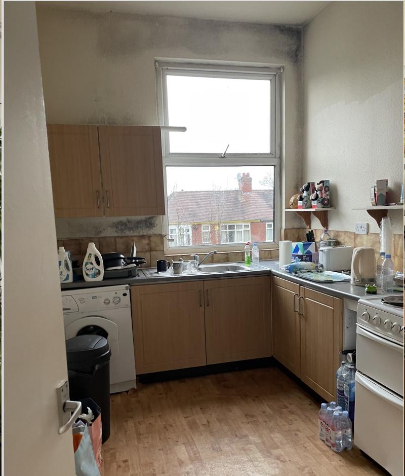 Bright corner kitchen with a large window overl...