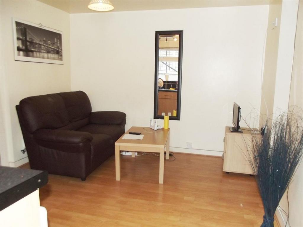 Bright, simply furnished living room with wood ...